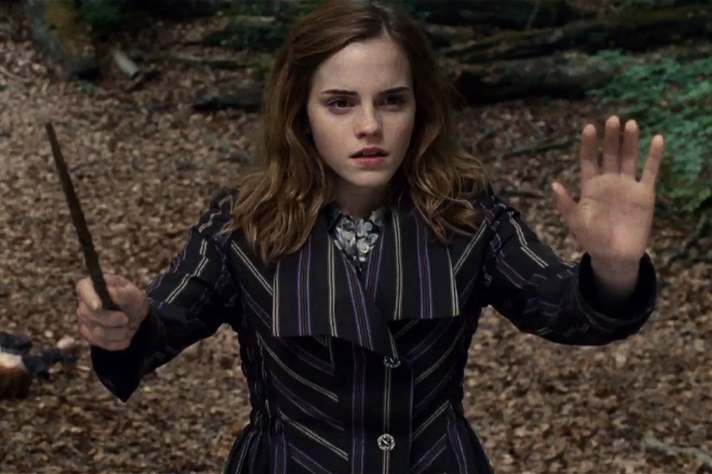 Hermione Granger holds her wand.